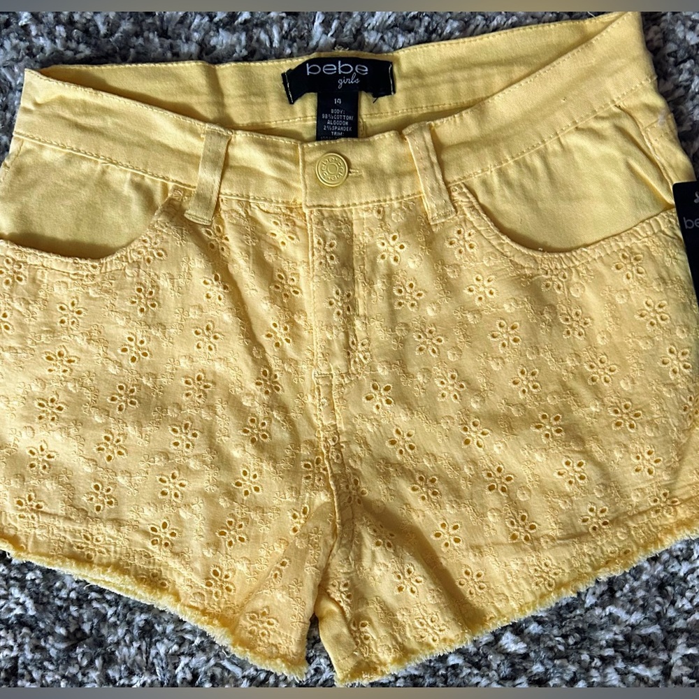 Girls shorts , size 14,(27”Waist)NWT, Bebe yellow,sits on hips.Has stretch